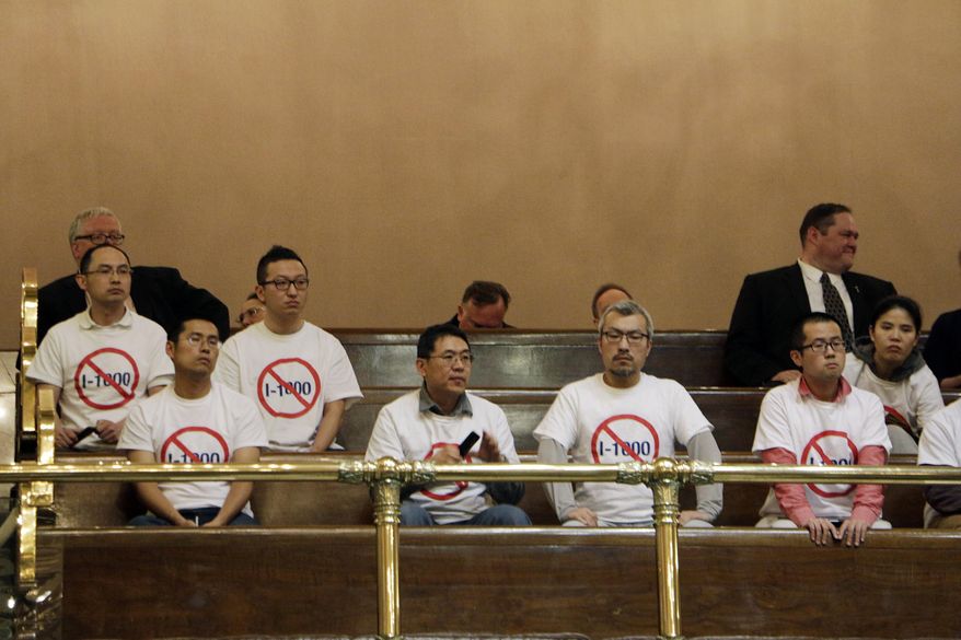 Opponents of an initiative to the Legislature that would allow the state to use hiring and recruitment goals, but not quotas, to bring minority candidates into state jobs, education, and contracting sit in the public gallery in the Washington House, on Sunday, April 28, 2019, in Olympia, Wash. The measure loosens restrictions enacted in a separate 1998 initiative that banned government discrimination or preferential treatment based on factors like race or gender. (AP Photo/Rachel La Corte)