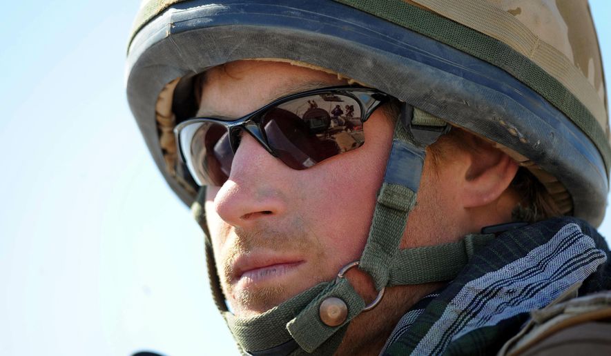 In this Feb. 18, 2008 file photo, Britain&#x27;s Prince Harry, sits atop a military vehicle in the Helmand province, Southern Afghanistan. Princess Diana’s little boy the devil-may-care red-haired prince with the charming smile is about to become a father. The arrival of the first child for Prince Harry and his wife Meghan will complete the transformation of Harry from troubled teen to family man, from source of concern to source of national pride. (John Stillwell, Pool Photo via AP, File)