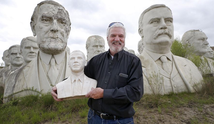 Howard Hankins holds a bust of former President Barack Obama Friday, April 19, 2019 after it was returned to his Croaker, Va., farm. A Richmonder, who took the bust when joining the Presidents Heads Walking Tour led by photographer John Plashal, returned it. (Alexa Welch Edlund/Richmond Times-Dispatch via AP)/Richmond Times-Dispatch via AP)