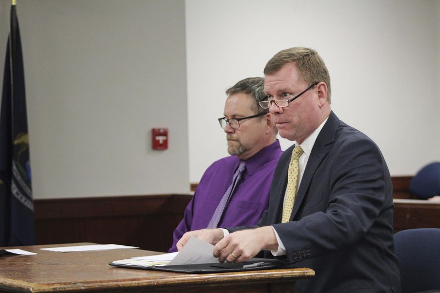 In a April 16, 2019 photo, Ionia County Probate Court Judge Robert Sykes Jr., right, updates the Ionia County Board of Commissioners about probate and juvenile court cases during a meeting as Director of Juvenile Services Mark Jewell listens in Ionia, Mich.Sykes says an encounter with methamphetamine inside the courthouse where he works serves as a warning about the extent of the drug epidemic. (Elisabeth Waldon/The Daily News via AP)