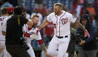 Washington Nationals&#39; Matt Adams, right, celebrates as he heads home after hitting a walk-off home run during the 11th inning of a baseball game against the San Diego Padres, Sunday, April 28, 2019, in Washington. The Nationals won 7-6 in 11 innings. (AP Photo/Nick Wass)