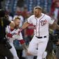 Washington Nationals&#39; Matt Adams, right, celebrates as he heads home after hitting a walk-off home run during the 11th inning of a baseball game against the San Diego Padres, Sunday, April 28, 2019, in Washington. The Nationals won 7-6 in 11 innings. (AP Photo/Nick Wass)