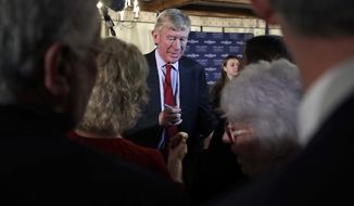 Former Massachusetts Gov. William Weld signs autographs during a New England Council &#39;Politics &amp; Eggs&#39; breakfast in Bedford, N.H., Friday, Feb. 15, 2019. Weld announced he&#39;s creating a presidential exploratory committee for a run in the 2020 election. (AP Photo/Charles Krupa)