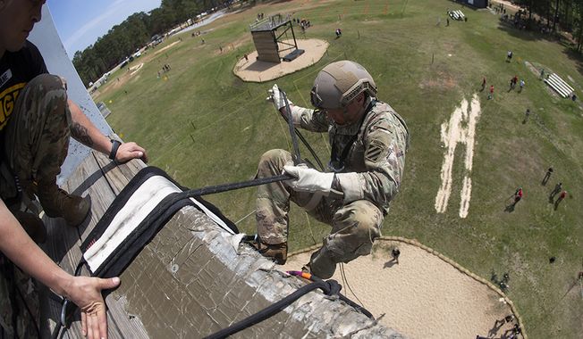 An Army Ranger rappels off a tower during the Day Stakes portion of the Best Ranger competition Saturday, April 13, 2019, at Fort Benning, Ga. (AP Photo/John Bazemore) **FILE**