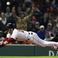 Boston Red Sox&#39;s Andrew Benintendi dives for home plate as he beats the throw to score on a sacrifice fly by Xander Bogaerts during the eighth inning of a baseball game against the Oakland Athletics at Fenway Park, Monday, April 29, 2019, in Boston. (AP Photo/Charles Krupa)