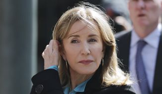 In this April 3, 2019, file photo, actress Felicity Huffman arrives at federal court in Boston to face charges in a nationwide college admissions bribery scandal. Huffman will plead guilty on May 13 to charges that she took part in the cheating scam. She had been scheduled to enter her plea on May 21, but a judge agreed to move up the hearing because the lead prosecutor will be out of town. (AP Photo/Charles Krupa, File)