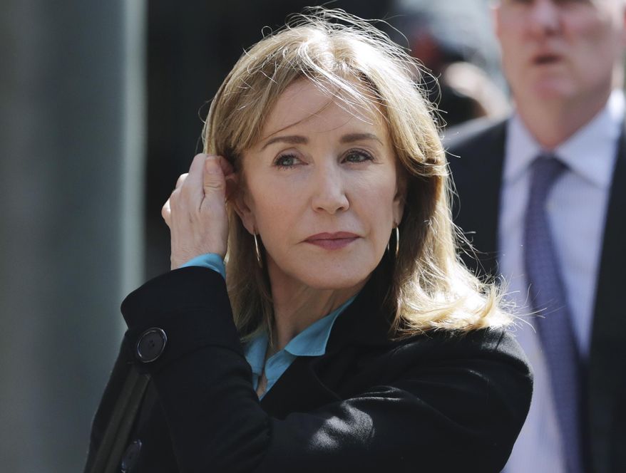 In this April 3, 2019, file photo, actress Felicity Huffman arrives at federal court in Boston to face charges in a nationwide college admissions bribery scandal. Huffman will plead guilty on May 13 to charges that she took part in the cheating scam. She had been scheduled to enter her plea on May 21, but a judge agreed to move up the hearing because the lead prosecutor will be out of town. (AP Photo/Charles Krupa, File)