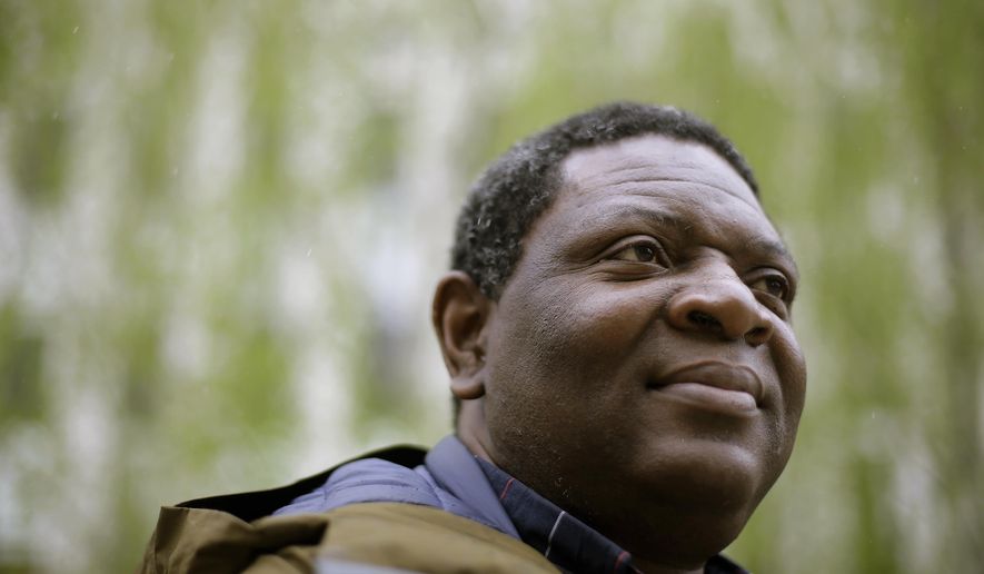 In this Monday, April 22, 2019 photo Goldman Environmental Prize winner Alfred Brownell, a Liberian environmental lawyer and human rights activist, stands for a photograph, in Boston. Brownell, a distinguished scholar at Northeastern University School of Law in Boston, says he was forced to flee his country over his fight to hold a Southeast Asian palm oil company accountable for its alleged destruction of Liberian forest and abuse of indigenous communities living around palm oil plantations. (AP Photo/Steven Senne)