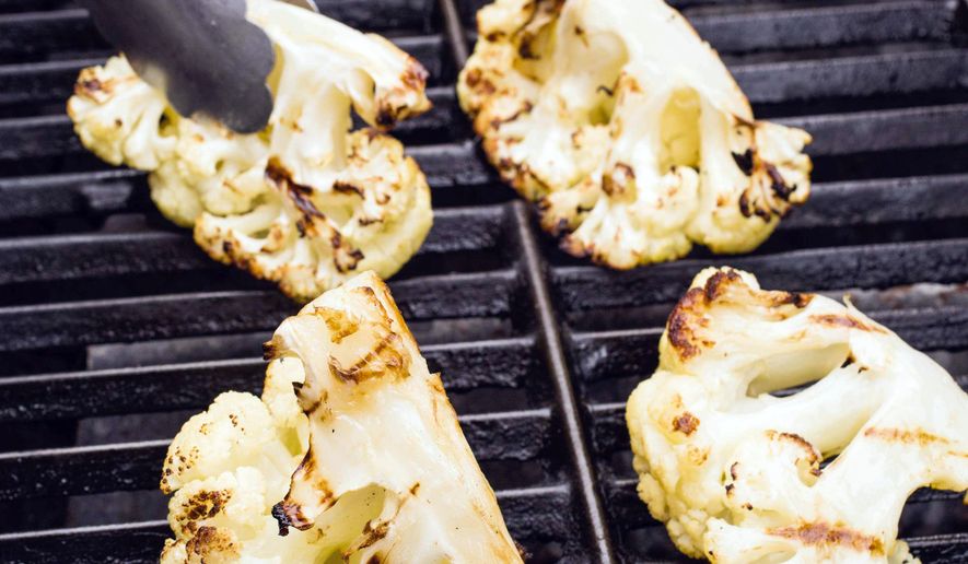 This image provided by America's Test Kitchen shows grilled cauliflower. (America's Test Kitchen via AP)