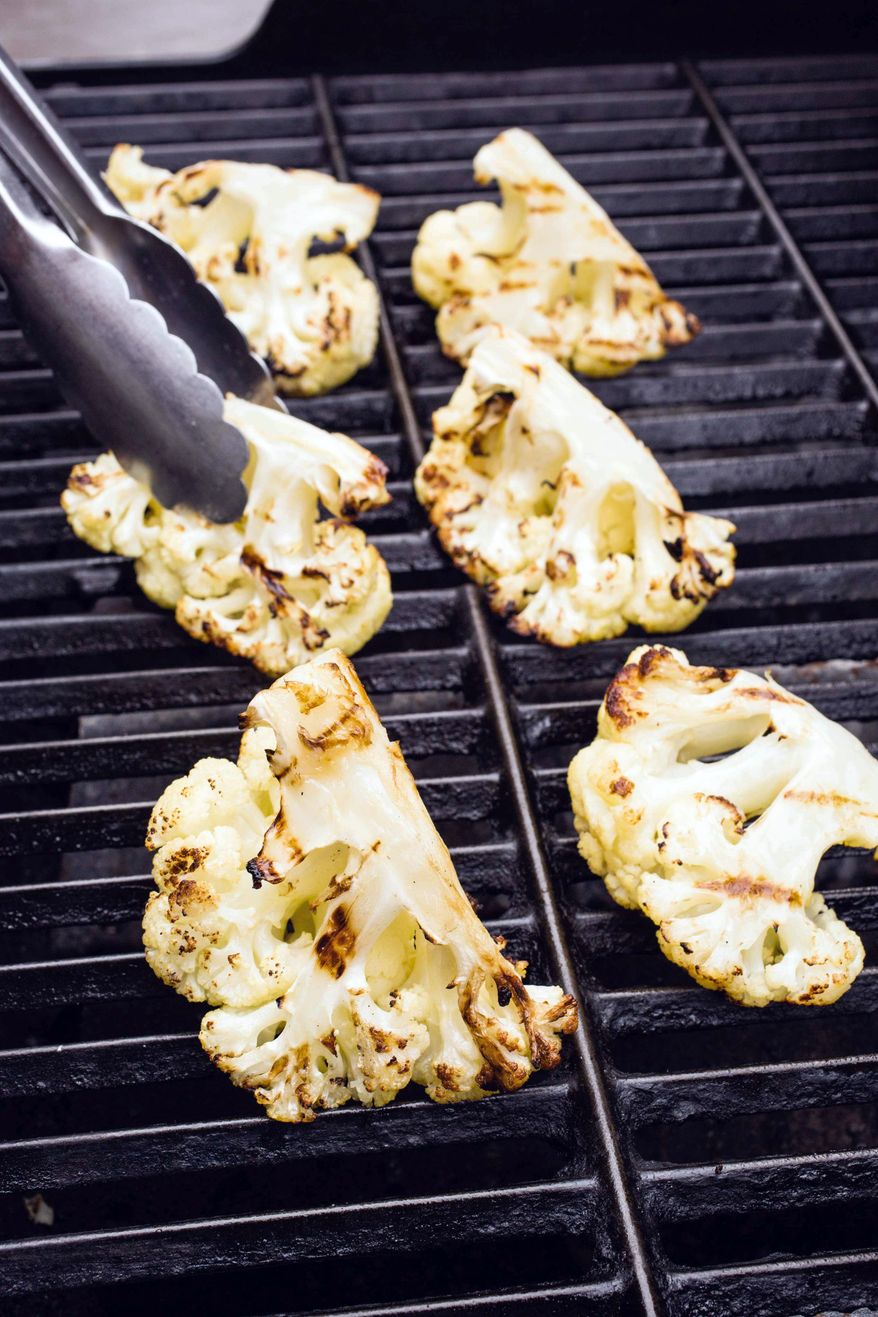 This image provided by America's Test Kitchen shows grilled cauliflower. (America's Test Kitchen via AP)