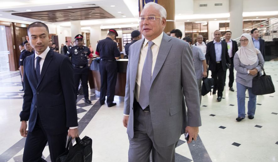 Former Malaysian Prime Minister Najib Razak, center, walks in a courtroom at Kuala Lumpur High Court in Kuala Lumpur, Malaysia, Monday, April 29, 2019. Najib, his former deputy and several high-ranking former officials have already been charged with corruption after the election ushered in the first change of power since Malaysia&#39;s independence from Britain in 1957. (AP Photo/Vincent Thian)