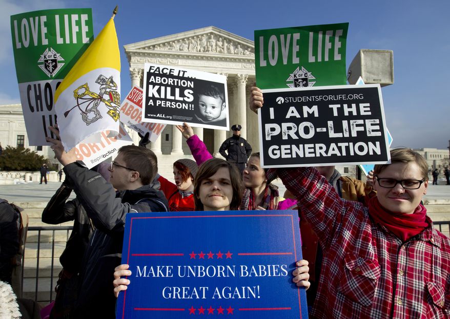 In this Friday, Jan. 18, 2019, file photo, anti-abortion activists protest outside of the U.S. Supreme Court, during the March for Life in Washington. (AP Photo/Jose Luis Magana) ** FILE **