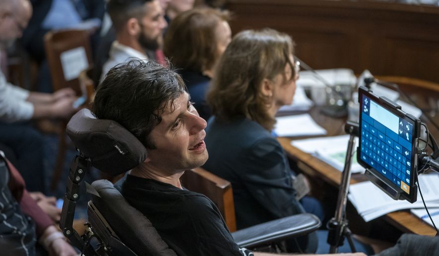 Ady Barkan, a high-profile health care activist who suffers from Amyotrophic lateral sclerosis, testifies before the House Rules Committee at a hearing on a "Medicare for All" bill for government-provided health care, on Capitol Hill in Washington, Tuesday, April 30, 2019. (AP Photo/J. Scott Applewhite)