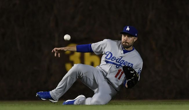 Los Angeles Dodgers center fielder A.J. Pollock catches a fly ball hit by Chicago Cubs' Cole Hamels during the third inning of a baseball game Wednesday, April 24, 2019, in Chicago. (AP Photo/Paul Beaty)