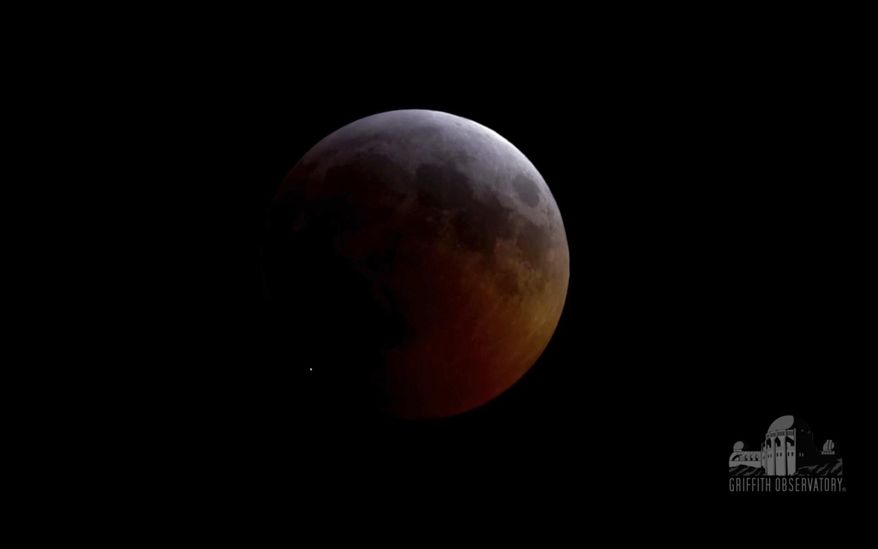 FILE - This image from video provided by Griffith Observatory in Los Angeles shows an impact flash on the moon, bottom left, during the lunar eclipse which started on Sunday evening, Jan. 20, 2019. On Tuesday, April 30, 2019, scientists reported the meteoroid hit the moon at 38,000 mph (61,000 kph), carving out a crater nearly 50 miles (15 meters) across. It was the first impact flash ever observed during a lunar eclipse. (Griffith Observatory via AP)