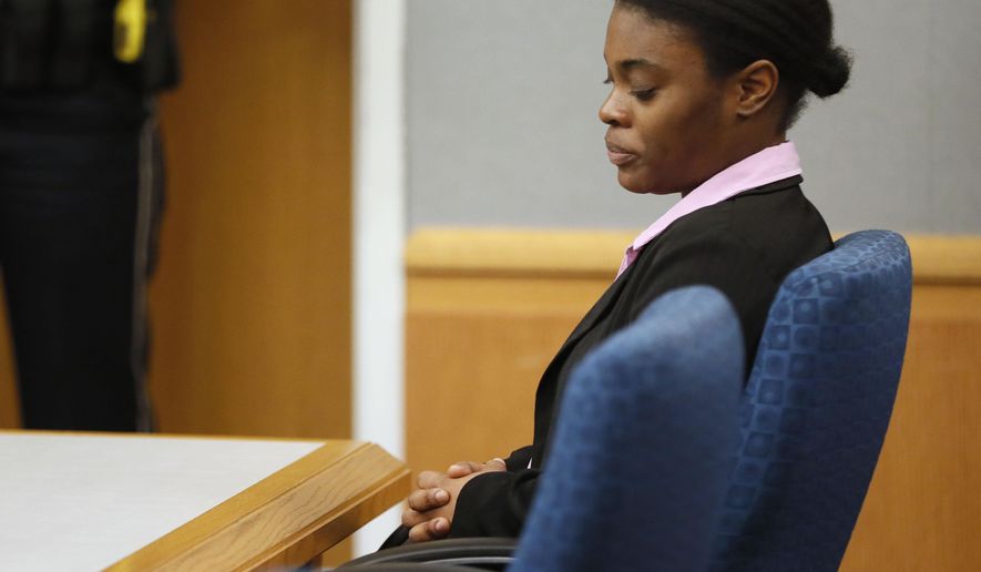 Tiffany Moss listens as a jury sentences her, Tuesday, April 30, 2019, in Lawrenceville, Ga. Moss, who found guilty Monday of all counts including murder, cruelty to children and trying to conceal the death of 10-year-old Emani Moss by burning her body in a trash can in 2013, was sentenced to death. (Bob Andres/Atlanta Journal-Constitution via AP)