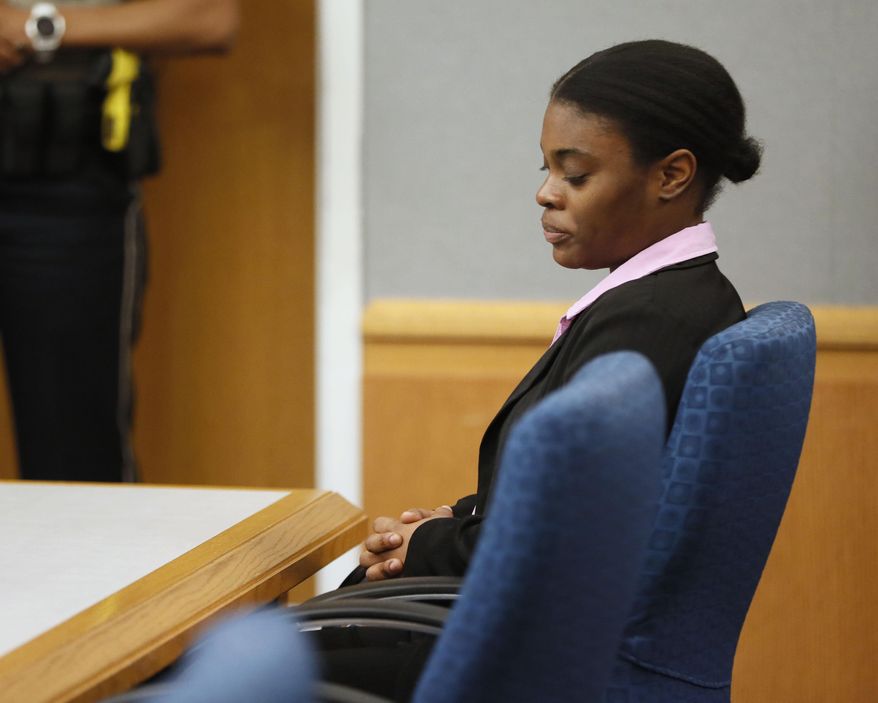 Tiffany Moss listens as a jury sentences her, Tuesday, April 30, 2019, in Lawrenceville, Ga. Moss, who found guilty Monday of all counts including murder, cruelty to children and trying to conceal the death of 10-year-old Emani Moss by burning her body in a trash can in 2013, was sentenced to death. (Bob Andres/Atlanta Journal-Constitution via AP)