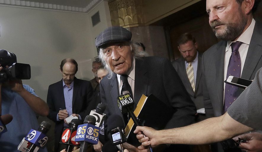 FILE - In this July 3, 2018, file photo, attorneys Tony Serra, center, and Brian Getz, right, representing Derick Almena, speak to reporters at a courthouse in Oakland, Calif. More than two years after 36 people died in the fire, Almena and Max Harris, the two men who face charges of involuntary manslaughter, will stand trial on charges that they allegedly illegally converted the industrial building into an unlicensed entertainment venue and artist live-work space. (AP Photo/Jeff Chiu, File)