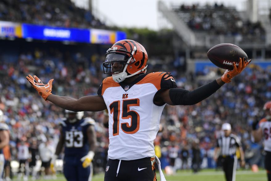 FILE - In this Dec. 9, 2018, file photo, Cincinnati Bengals wide receiver John Ross (15) celebrates after scoring a touchdown against the Los Angeles Chargers during the first half of an NFL football game in Carson, Calif. Receiver John Ross read reports that the Bengals were going to trade him during the draft. Not only did they keep him, they chose not to get any more receivers, leaving Ross with an important role. (AP Photo/Mark J. Terrill, File)