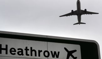 In this file photo dated Tuesday, June 5, 2018, a plane takes off over a road sign near Heathrow Airport in London. (AP Photo/Kirsty Wigglesworth, File)
