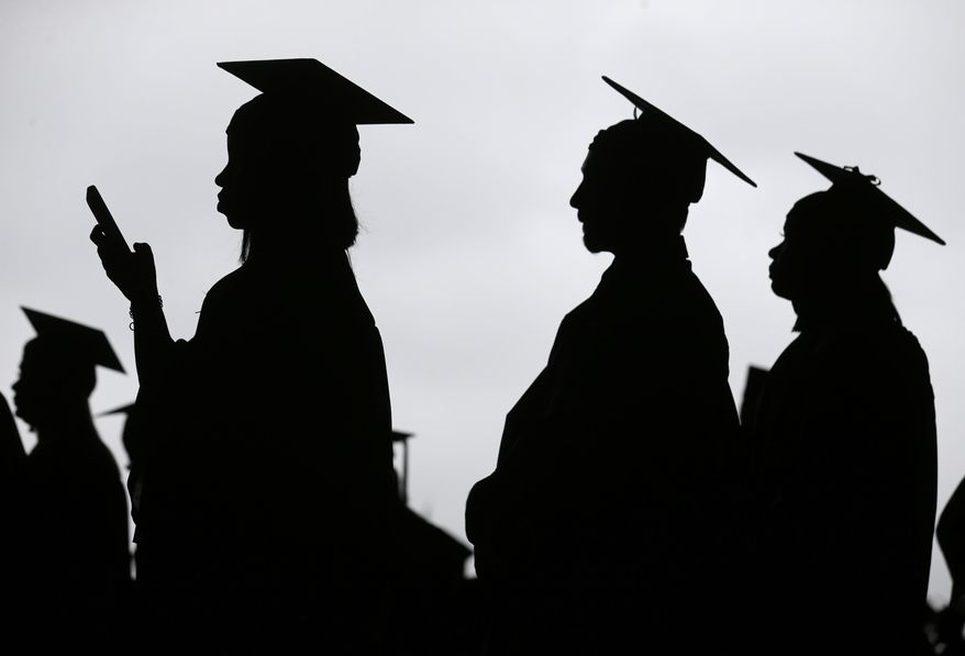 FILE - In this May 17, 2018, file photo, new graduates line up before the start of the Bergen Community College commencement at MetLife Stadium in East Rutherford, N.J. A college degree has long been a ticket to the U.S. middle class. Yet a new survey shows that college graduates aren’t as likely as they once were to feel they belong to the middle class. (AP Photo/Seth Wenig, File)