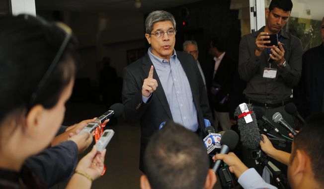 FILE - In this Dec. 12, 2018, file photo, Cuba&#x27;s Director-General of U.S. Affairs Carlos Fernandez de Cossio makes a statement to reporters, in Havana, Cuba. De Cossio says his nation has no troops in Venezuela but it maintains the right to military and intelligence cooperation with its ally. (AP Photo/Desmond Boylan, File)