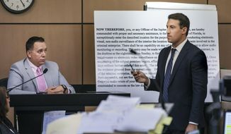 Alex Spiro, right, attorney for New England Patriots owner Robert Kraft, stands in front of a copy of a search warrant as he questions Jupiter Police Detective Andrew Sharp during a motion hearing in the Kraft prostitution solicitation case, Wednesday, May 1, 2019, in West Palm Beach, Fla. Kraft&#39;s attorneys argue that undercover surveillance videos allegedly showing their client paying for sex at a Jupiter day spa should be ruled inadmissible and the evidence thrown out. (Lannis Waters/Palm Beach Post via AP, Pool)