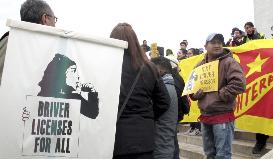 Supporters of immigrant rights rally outside the Wisconsin state Capitol in support of Democratic Gov. Tony Evers' proposal to make driver's licenses available to people living in the country illegally, Wednesday, May 1, 2019, in Madison, Wis.. The event was one of many happening across the country to demonstrate the economic power of Hispanics and draw attention to issues of concern. . (AP Photo/Scott Bauer)