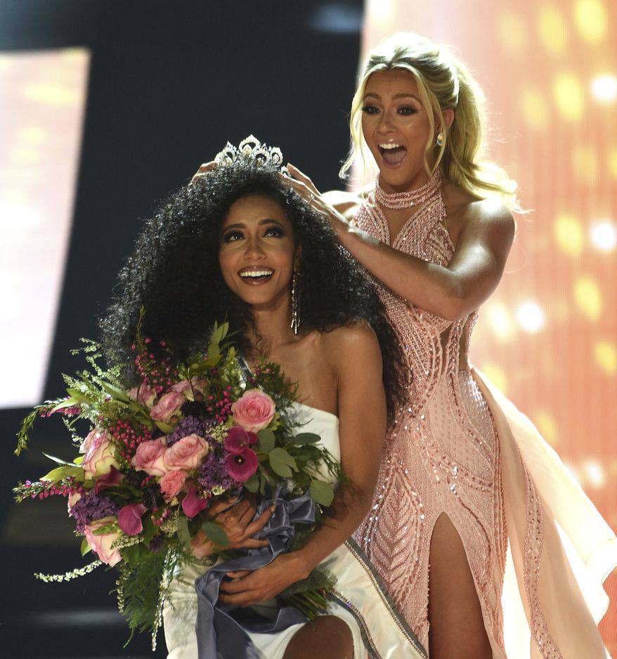 Miss North Carolina Cheslie Kryst gets crowned by last year's winner Sarah Rose Summers after winning the 2019 Miss USA final competition in the Grand Theatre in the Grand Sierra Resort in Reno, Nev., on Thursday, May 2, 2019. (Jason Bean/The Reno Gazette-Journal via AP)