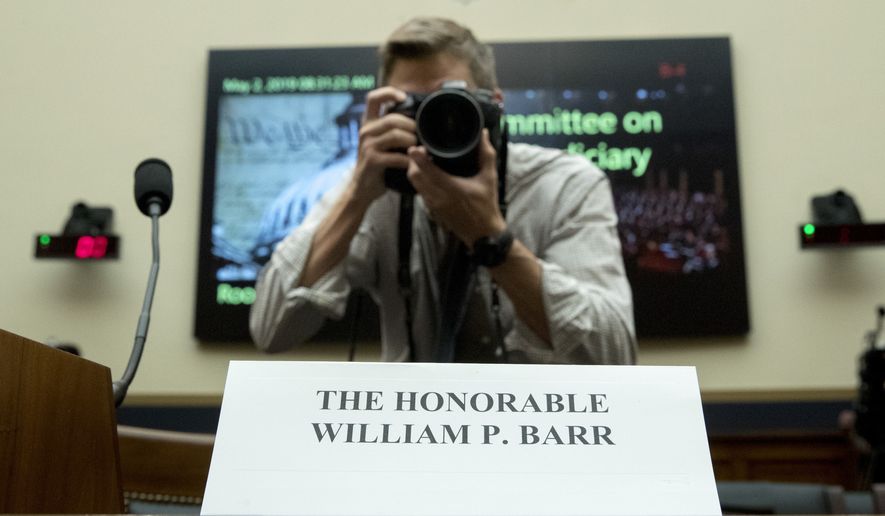 A photographer takes a photograph of a placard for Attorney General William Barr who is not expected to appear before a House Judiciary Committee hearing on Capitol Hill in Washington, Thursday, May 2, 2019. (AP Photo/Andrew Harnik)