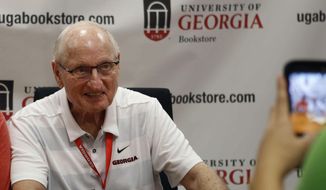 In this Sept. 29, 2018, file photo, Vince Dooley poses for a photo while signing autographs before a game between Georgia and Tennessee in Athens, Ga. (Jenn Finch/Athens Banner-Herald via AP, File) **FILE**