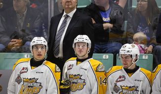 FILE - In this May 21, 2016, file photo, Brandon Wheat Kings head coach Kelly McCrimmon, top center, looks to the scoreboard with his players during second-period CHL Memorial Cup hockey game action against the Rouyn-Noranda Huskies in Red Deer, Alberta. The Vegas Golden Knights have promoted Kelly McCrimmon to general manager and kept George McPhee as president of hockey operations. McPhee and owner Bill Foley announced the unexpected move Thursday, May 2, 2019, amid speculation about other NHL teams being interested in McCrimmon. He had served as McPhee’s top assistant since August 2016, a year before the franchise made its on-ice debut. (Jeff McIntosh/The Canadian Press via AP, File)