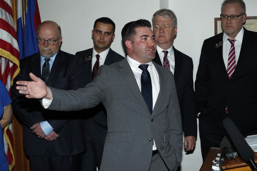 Colorado State Rep. Patrick Neville, front, makes a point as, from back left, Barry Arrington, who represents the advocacy group Rocky Mountain Gun Owners, Rep. Dave Williams, Dudley Brown, executive director of the gun group, and Rep. Stephen Humphrey look on during the announcement of plans to file a lawsuit to block a "red flag" law allowing courts to order firearms be taken away from people who pose a danger during a news conference in the State Capitol Thursday, May 2, 2019, in Denver. The Republicans and the group claim that House Democrats violated a section of the state constitution governing the legislative process to get the bill passed earlier this year. (AP Photo/David Zalubowski) ** FILE **