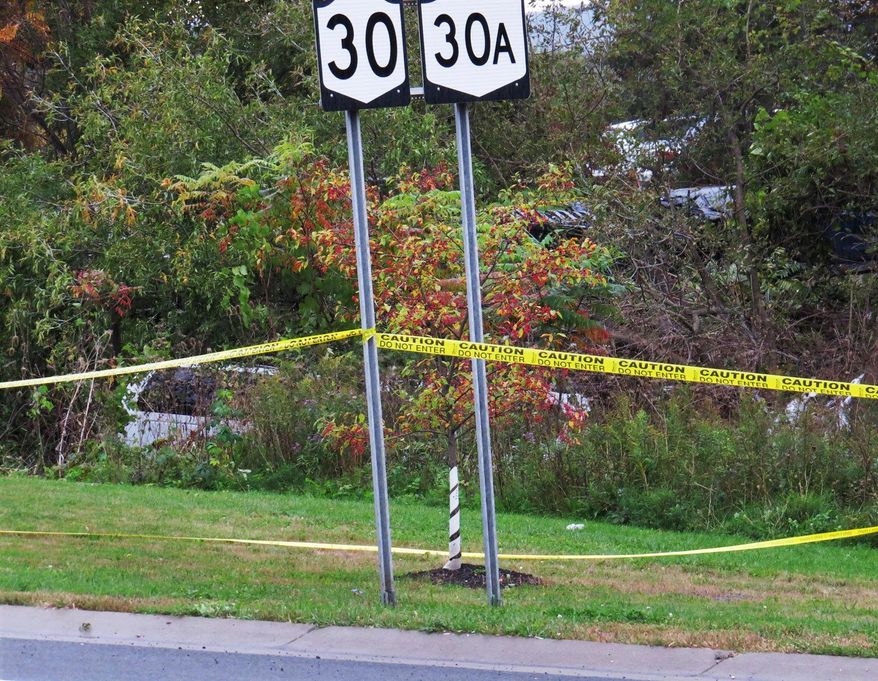 FILE - In this Oct. 6, 2018, file photo, a limousine, left, has landed in the woods following a fatal crash in Schoharie, N.Y. Twenty people died in the crash in rural Schoharie County involving a stretch limo that authorities have said should not have been on the road. During a legislative hearing Thursday, May 2, 2019 in Albany, N.Y., several parents of people killed in recent limousine crashes in New York called for stronger limo inspection rules; seat belts and air bags in all limos; as well as better enforcement to ensure vehicles and drivers have proper licenses. (Tom Heffernan Sr. via AP, File)