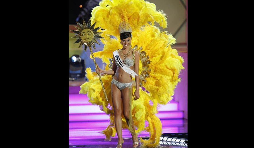 FILE - In this July 18, 2006 file photo, Miss Uruguay, Fatimih Davila, shows off a costume related to her home country during the preliminary competition for Miss Universe 2006 at the Shrine Auditorium in Los Angeles. Davila was found dead at a Mexico City hotel. City prosecutors said she was found hanged in the bathroom of one of the hotel’s rooms early Thursday, May 2 2019. (AP Photo/Lucas Jackson, File)