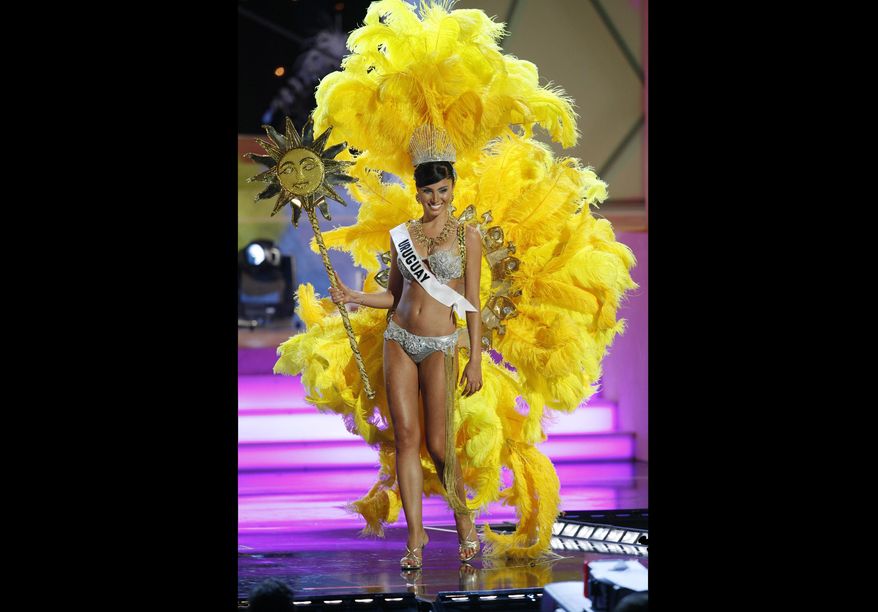 FILE - In this July 18, 2006 file photo, Miss Uruguay, Fatimih Davila, shows off a costume related to her home country during the preliminary competition for Miss Universe 2006 at the Shrine Auditorium in Los Angeles. Davila was found dead at a Mexico City hotel. City prosecutors said she was found hanged in the bathroom of one of the hotel’s rooms early Thursday, May 2 2019. (AP Photo/Lucas Jackson, File)