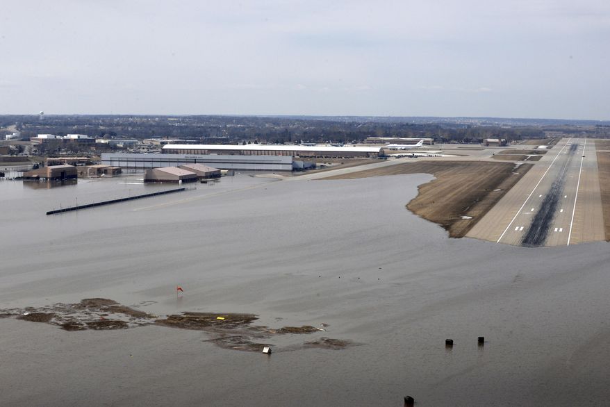 FILE - This March 17, 2019, file photo provided by the U.S. Air Force shows an aerial view of Offutt Air Force Base and the surrounding areas affected by floodwaters in Nebraska. The Air Force is raising its cost estimate to $420 million to repair and replace structures damaged at the Nebraska base following severe flooding that inundated buildings with water. (Tech. Sgt. Rachelle Blake/U.S. Air Force via AP, File)