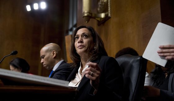 Democratic presidential candidates Sen. Cory Booker, D-N.J., left, and Sen. Kamala Harris, D-Calif., center, listen as Attorney General William Barr testifies during a Senate Judiciary Committee hearing on Capitol Hill in Washington, Wednesday, May 1, 2019, on the Mueller Report. (AP Photo/Andrew Harnik)