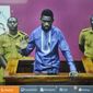 Ugandan pop star and opposition figure Bobi Wine, whose real name is Kyagulanyi Ssentamu, appears for his bail application via a video link from prison, on a television screen in a court in Kampala, Uganda Thursday, May 2, 2019. Wine was freed on bail Thursday after spending three nights in a maximum-security prison after being charged with disobeying statutory authority and facing trial over staging a street protest in July against a tax on social media. (AP Photo/Ronald Kabuubi)
