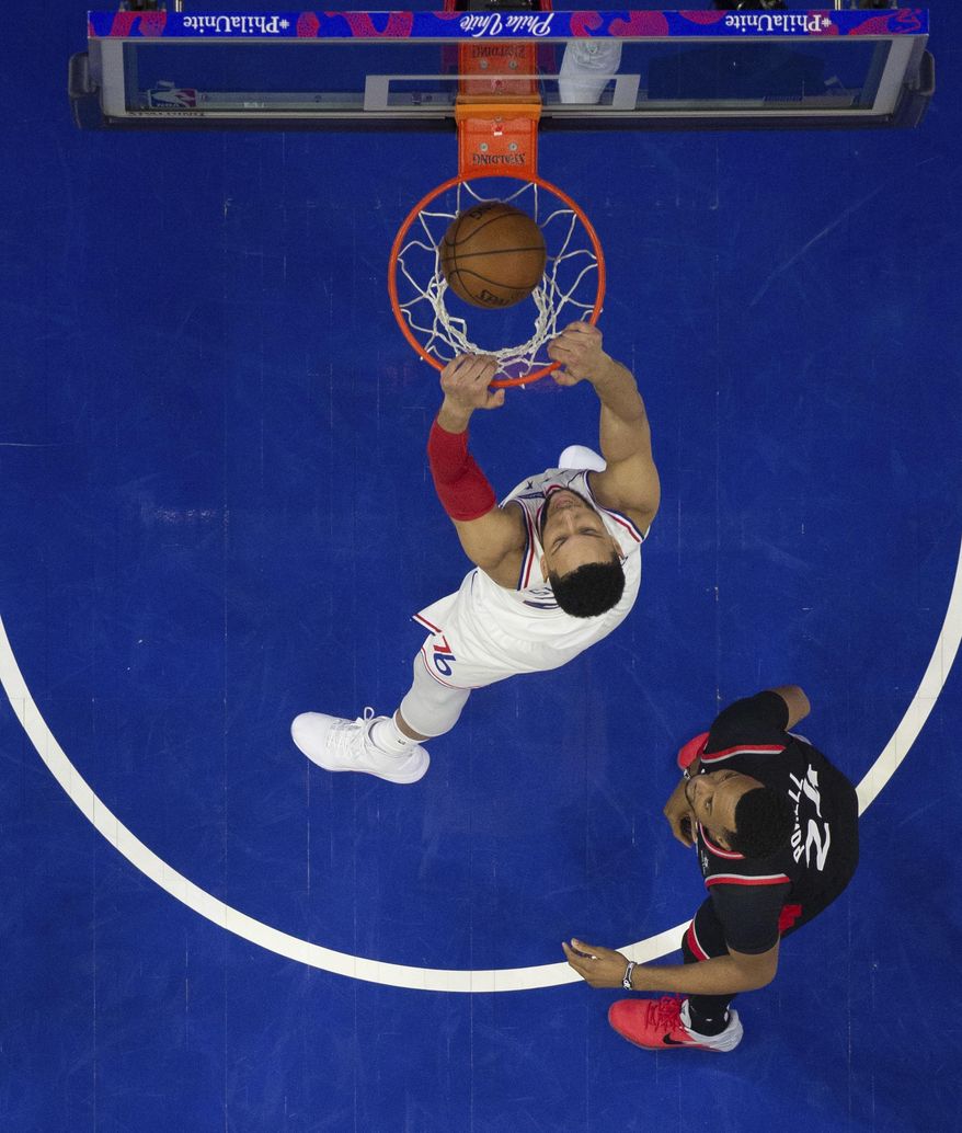 Philadelphia 76ers' Ben Simmons dunks as Toronto Raptors' Norman Powell, right, watches during the first half of Game 3 of a second-round NBA basketball playoff series Thursday, May 2, 2019, in Philadelphia. The 76ers won 116-95. (AP Photo/Chris Szagola)