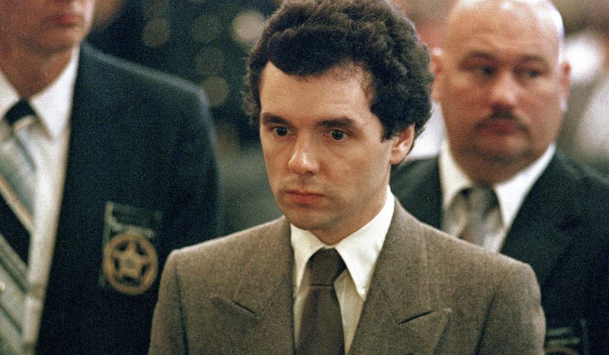 FILE – In this Sept. 1987 file photo, serial killer Donald Harvey stands before a judge during sentencing in Cincinnati. James Elliott, an Ohio inmate has been charged in the fatal 2017 prison beating of a serial killer dubbed the "Angel of Death." The indictment announced Friday, May 3, 2019 comes two years after Donald Harvey died when he was beaten at the state prison in Toledo. The former nurse's aide was serving multiple life sentences after admitting in 1987 to killing three dozen hospital patients in Ohio and Kentucky during the 1970s and '80s. (AP Photo/Al Berhman, File)