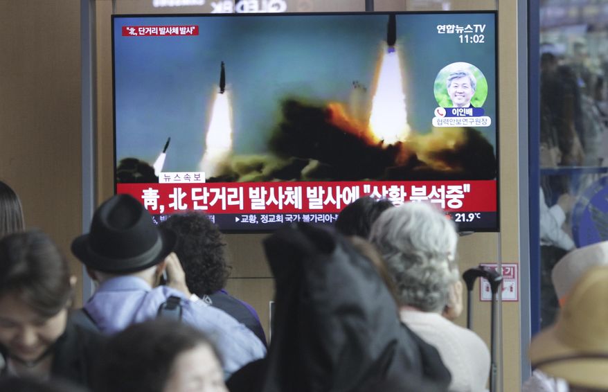 People watch a TV showing a file footage of North Korea's missile launch during a news program at the Seoul Railway Station in Seoul, South Korea, Saturday, May 4, 2019. North Korea on Saturday fired several unidentified short-range projectiles into the sea off its eastern coast, the South Korean Joint Chiefs of Staff said, a likely sign of Pyongyang's growing frustration at stalled diplomatic talks with Washington meant to provide coveted sanctions relief in return for nuclear disarmament. The signs read: " North Korea fired short-range missiles." (AP Photo/Ahn Young-joon)