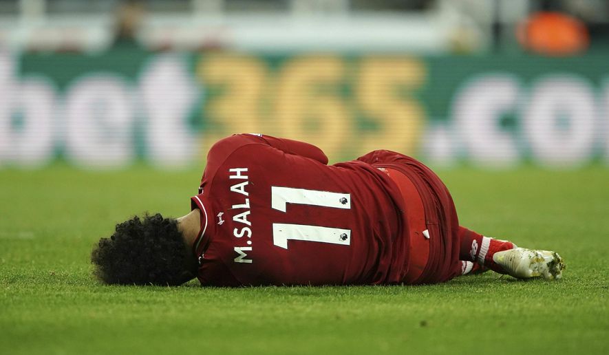Liverpool's Mohamed Salah lies injured during a Premier League match against Newcastle United at St James' Park, Newcastle, England, Saturday May 4, 2019. (Owen Humphreys/PA via AP)