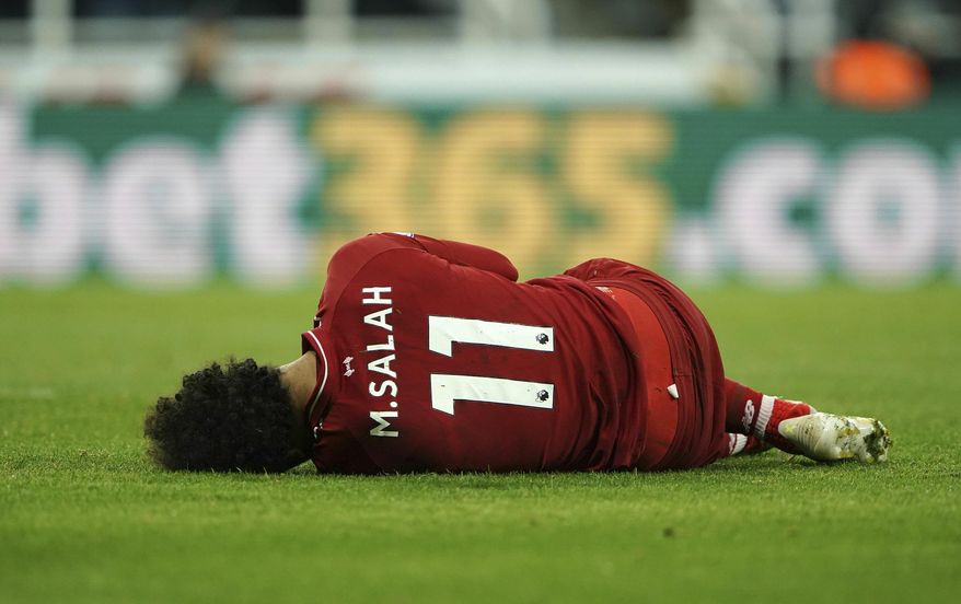 Liverpool's Mohamed Salah lies injured during a Premier League match against Newcastle United at St James' Park, Newcastle, England, Saturday May 4, 2019. (Owen Humphreys/PA via AP)