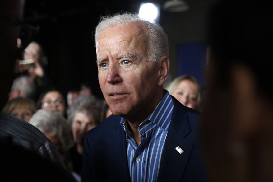 In this May 1, 2019, file photo, former Vice President and Democratic presidential candidate Joe Biden greets audience members during a rally in Iowa City, Iowa. (AP Photo/Charlie Neibergall) ** FILE **