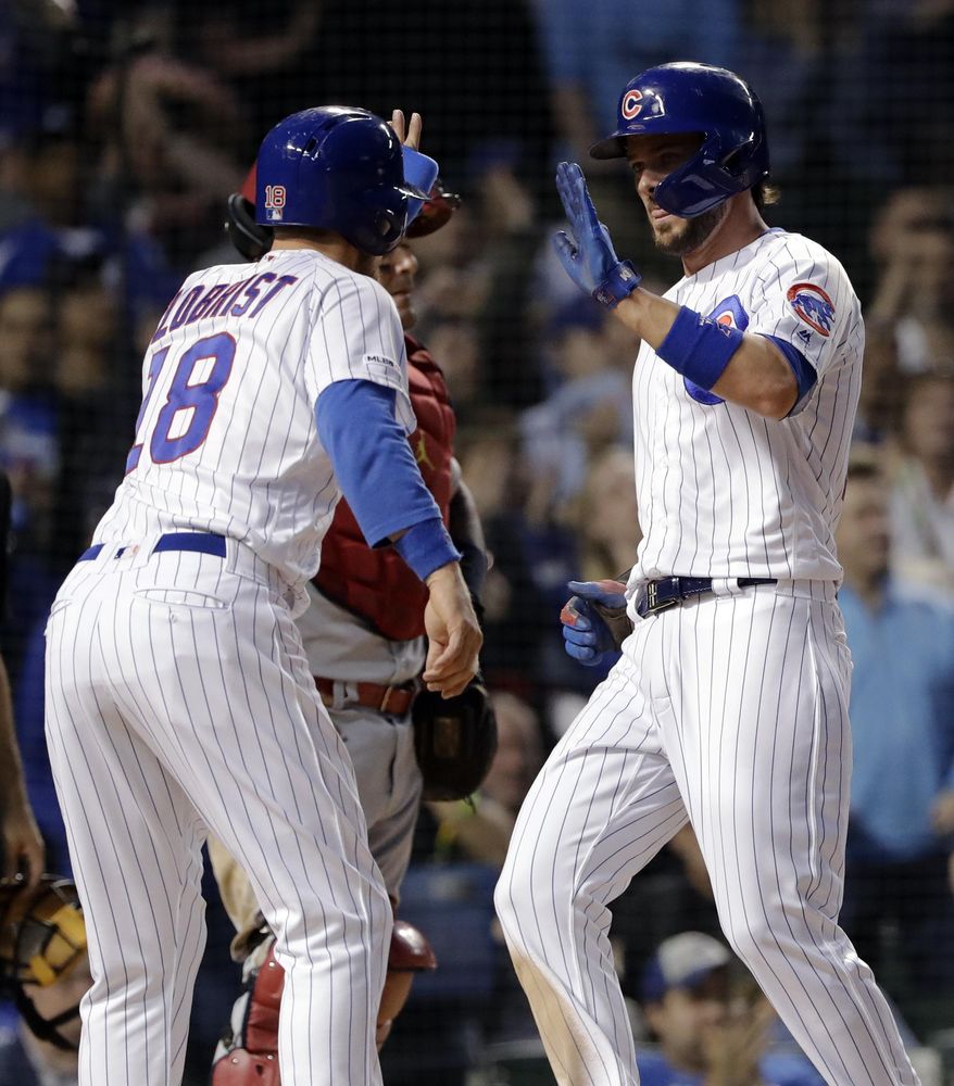 Chicago Cubs' Ben Zobrist celebrates with Kris Bryant after they scored on a two-run double by Anthony Rizzo during the sixth inning of a baseball game against the St. Louis Cardinals, Sunday, May 5, 2019, in Chicago. (AP Photo/Nam Y. Huh)