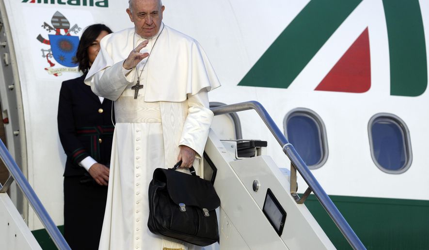 Pope Francis boards the airplane on the occasion of a three-day trip to Bulgaria and Macedonia at Rome's Fiumicino International airport, Sunday, May 5, 2019. (AP Photo/Gregorio Borgia)