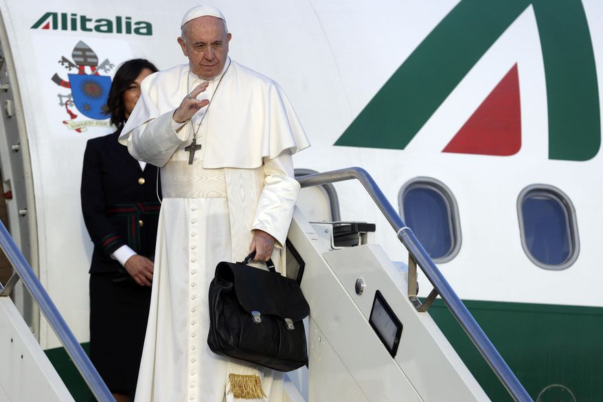Pope Francis boards the airplane on the occasion of a three-day trip to Bulgaria and Macedonia at Rome's Fiumicino International airport, Sunday, May 5, 2019. (AP Photo/Gregorio Borgia)