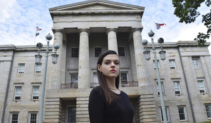 In this April 25, 2019, photo, North Carolina resident Leah McGuirk poses for a photo in Raleigh, N.C. McGuirk is an advocate for a bill that would make it illegal to tamper with someone's drink and would close other loopholes in the state's sexual assault laws. McGuirk experienced a seizure after one of her drinks was drugged in May 2018. (AP Photo/Amanda Morris)