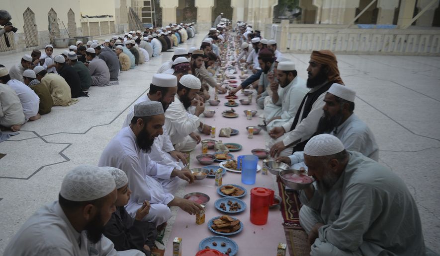 In this photo, Pakistani Muslims wait to break their fast during the fasting month of Ramadan at a mosque in Peshawar, Pakistan, Monday, May 6, 2019. Muslims around the world are observing Ramadan, the holiest month in Islamic calendar. (AP Photo/Muhammad Sajjad) **FILE**